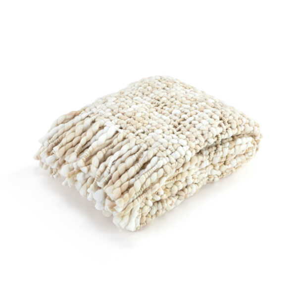 A loosely woven cream fringed blanket displayed folded.